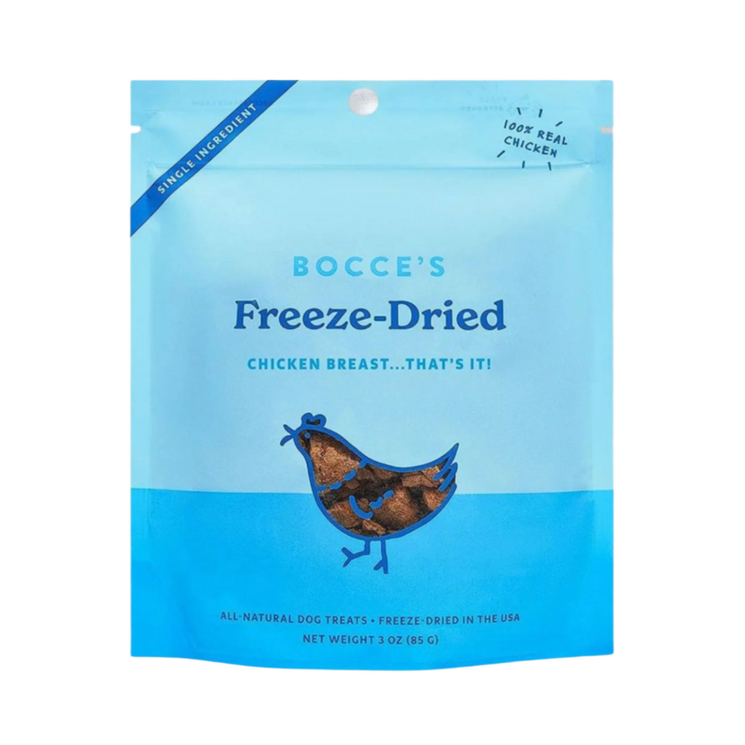 Freeze-dried chicken breast dog treats from Bocce's Bakery in a 3oz package, displayed on a white wooden background.