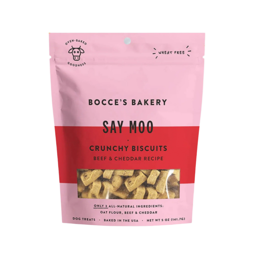 Bocces Bakery Say Moo Crunchy Biscuits: Wheat-free dog treats with beef and cheddar recipe, packaged in a pink and red bag.