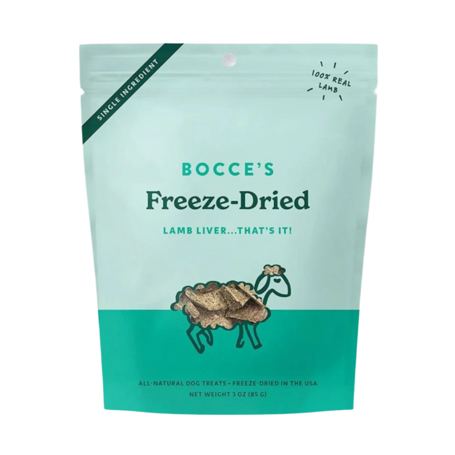 Freeze-dried lamb liver dog treats from Bocce's Bakery, a 3oz. resealable pouch with an illustrated sheep icon on the packaging, placed on a white wooden surface.