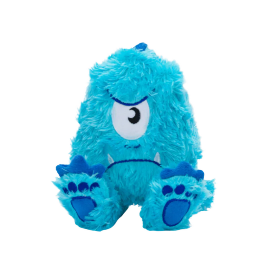 Bright blue fluffy plush monster toy with one eye and large feet, placed on a white wooden background.