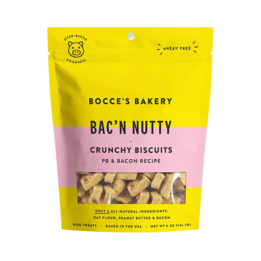 Crunchy peanut butter and bacon-flavored dog treats by Bocce's Bakery, packaged in a yellow and pink bag with the brand name and product description displayed prominently.