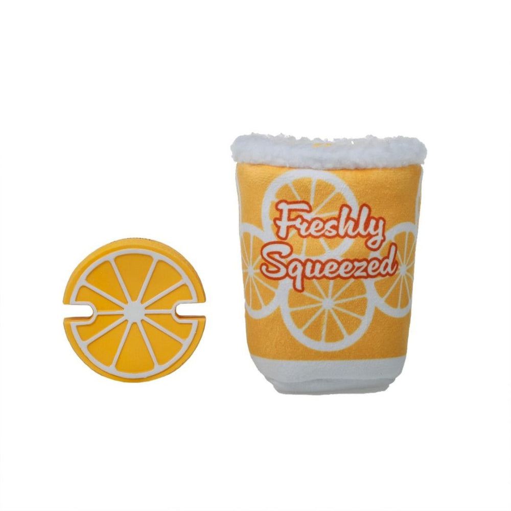 Plush yellow dog toy with "Freshly Squeezed" text and orange lemon slice design, placed on a white background.