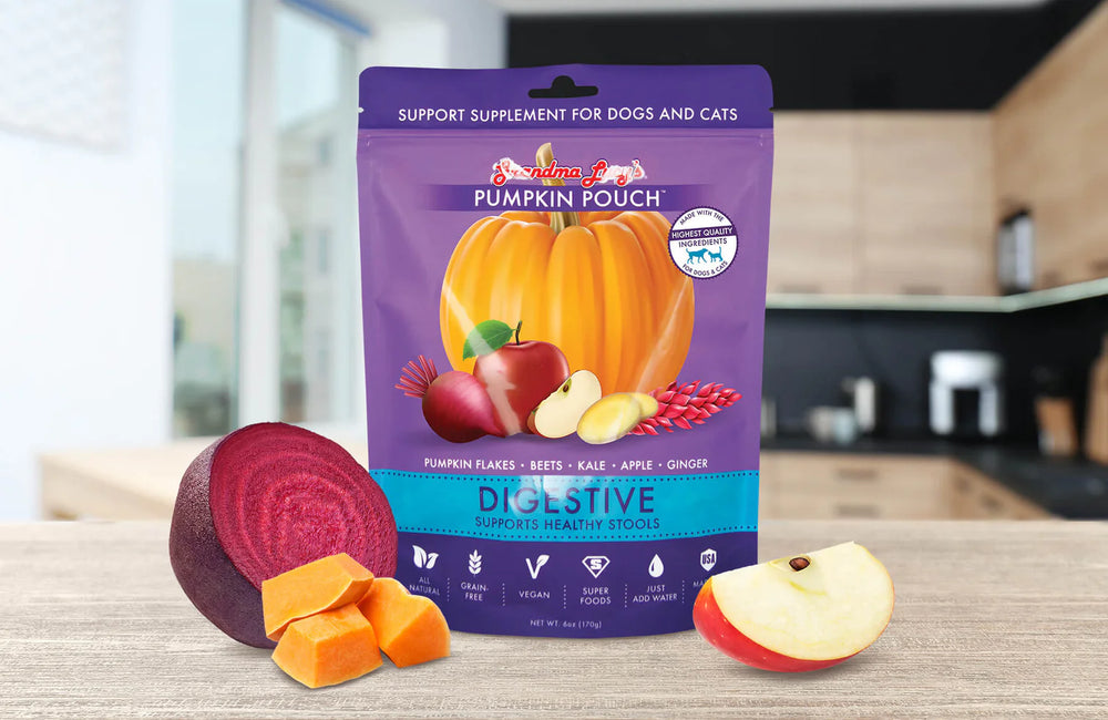 Freeze-dried pumpkin pouch for dogs and cats digestive support, featuring pumpkin, apples, beets, and other ingredients, displayed on a wooden surface alongside fresh produce.