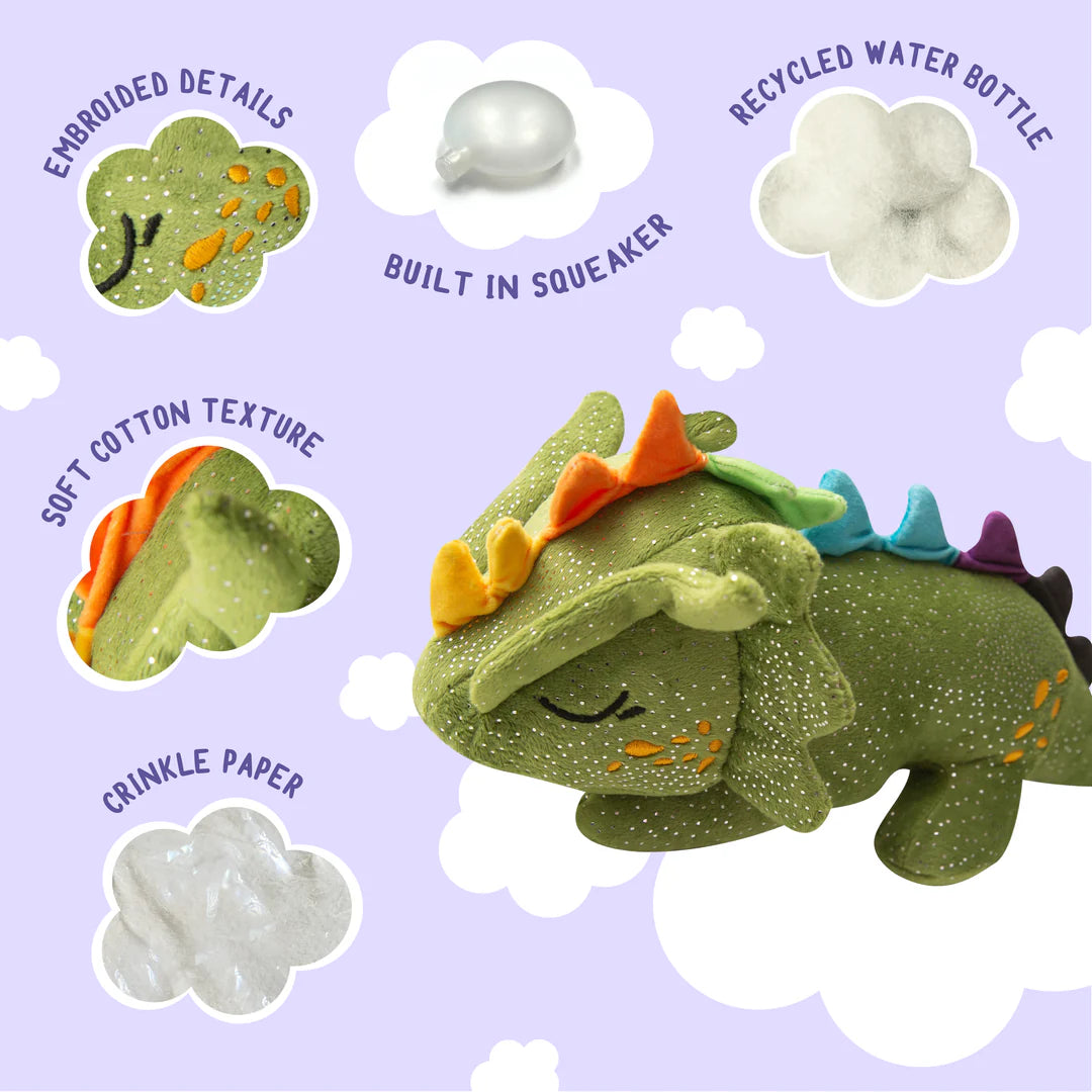 Soft cotton texture plush green dinosaur toy with spiked details, built-in squeaker, and recycled water bottle used in its construction, displayed against a light lavender background.